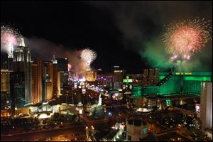 Fireworks explode from the tops of casinos on the Strip during the annual New Year's Eve celebration in Las Vegas.