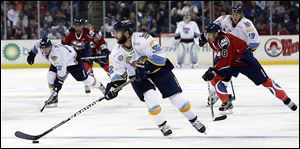 Walleye defenseman Cody Lampl, center, prides himself on being able to move the puck to the team's forwards quickly as he maneuvers up the ice recently against Kalamazoo at the Huntington Center.