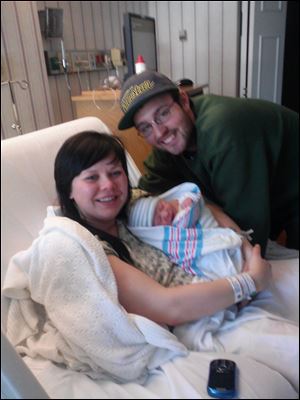 Proud parents Brittany Spoldt and Dan Poulin hold the Toledo area's first baby of 2013 Eli John. Eli was born at Flower Hospital in Sylvania at 1:28 a.m.