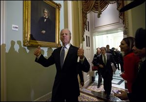 Vice President Joe Biden gives two thumbs up following a Senate Democratic caucus meeting about the fiscal cliff Monday night on Capitol Hill.