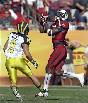 South Carolina cornerback Jimmy Legree (15) intercepts a pass intended for Michigan wide receiver Drew Dileo (9) during the first quarter of the Outback Bowl in Tampa, Fla.