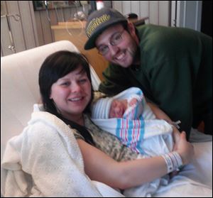 Proud parents Britney Spoldt and Dan Poulin hold the Toledo area's first baby of 2013 Eli John. Eli was born at Flower Hospital in Sylvania at 1:28 a.m.