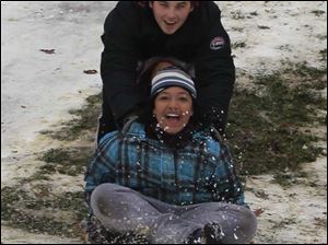 ROV sledding01p  Sliding are, from front: Alayna (cq) Johnson, 11, Carly Neiswender, 11, [mostly obscured], and her brother Ryan Neiswender, 15, all of Toledo. Sledding down one of the hills in Ottawa Park in Toledo.