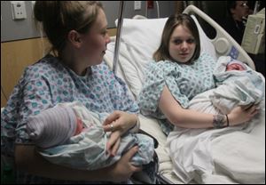 Twin sisters Aimee Nelson, left, and Ashlee Nelson, both of Cuyahoga Falls, hold their newborn sons Donavyn Bratten, left, and Aiden Lee Alan Dilts at Summa City Hospital on Monday in Akron. 