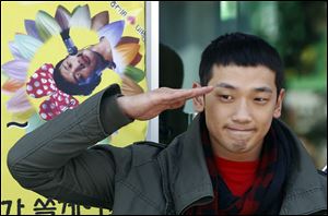 South Korean pop singer Rain gives a military salute to his fans before he enters the army to serve in October, 2011.