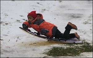 Brandon Sims, 9, hits a ramp sledding down one of the hills in Ottawa Park in Toledo.