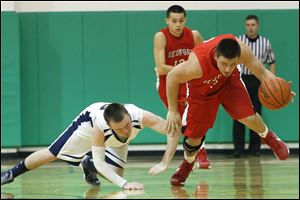 Bedford's Dennis Guss steals the ball from Lakota's Nathan Ray. Guss, a 5-11 senior, averages 9.6 points per game.