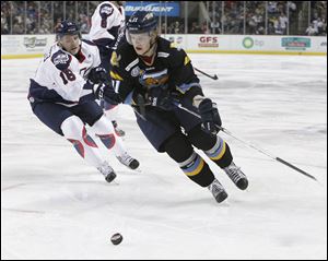 Walleye player Andrej Nestrasil takes the puck past Kalamazoo's Joe Charlebois during a game last month.