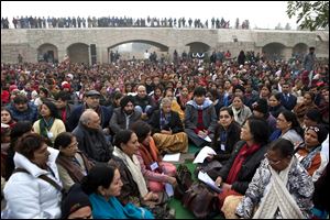 Chief Minister of Delhi state Sheila Dikshit, center, along with others offer prayers for a gang rape victim, at Mahatma Gandhi memorial, in New Delhi, India.