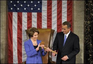 House Minority Leader Nancy Pelosi of Calif. passes the gavel today to House Speaker John Boehner of Ohio, who was re-elected as House Speaker of the 113th Congress.