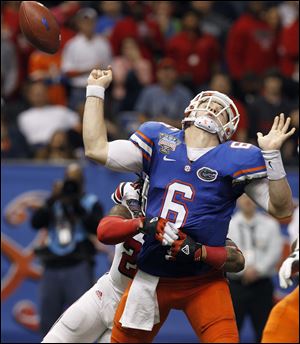 Louisville safety Calvin Pryor (25) causes Florida quarterback Jeff Driskel (6) to fumble the ball during the second half. Louisville recovered and scored on the next play.