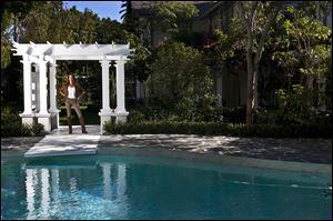 Morgan Brown poses at a luxury home in Los Angeles, California, in, that she bought, fixed up and is trying to flip. 
