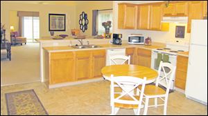 Step inside this large eat-in kitchen and admire its maple cabinetry and stylish accents.