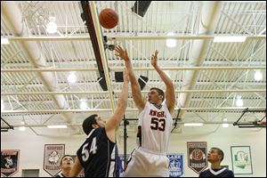 Otsego's senior A.C. Limes (53) puts up two points over Lake's senior Marcus Pierce (54).