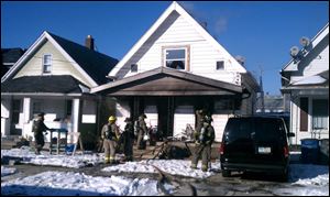 Fire crews work on a house fire at 270 E. Pearl St. in North Toledo.