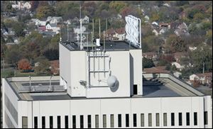 The twisty white wind turbines installed on the roof of One Government Center, at top right, have been idle for nearly a year.