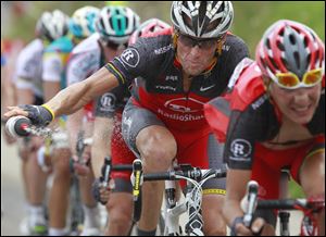 Lance Armstrong throws out his water bottle in the last kilometers of the climb toward Station les Rousses, France, during the seventh stage of the Tour de France cycling race. 