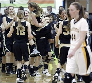 Perrysburg celebrates defeating  Sylvania Northview 53-49 in double overtime.