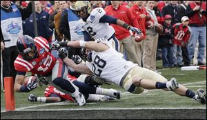 Mississippi wide receiver Donte Moncrief (12) is stopped short of the goal by Pittsburgh defensive back Anthony Gonzalez (28).