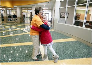 Principal Toni Gerber hugs third grader Madison Taylor while she welcomed students and families Saturday to tour the new Central Trail Elementary for the first time.