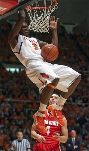 Illinois guard Brandon Paul dunks as Ohio State guard Aaron Craft looks on Saturday in Champaign, Ill.