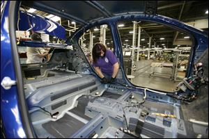 Tammy Ballard works on a Chevrolet Sonic at the General Motors Orion Assembly plant in Orion Township, Mich.