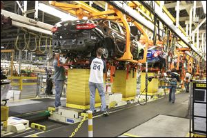 A drive train assembly is mated to a Buick Verano at the Orion Assembly plant in Orion Township, Mich. Nearly four years after GM filed for bankruptcy protection, the automaker is building the Verano and the Sonic, the best-selling subcompact car in the nation.