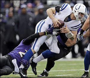 Ravens cornerback Corey Graham, left, and outside linebacker Paul Kruger sack the Colts' Andrew Luck. The rookie lost in his debut playoff game after winning 11 games this season.