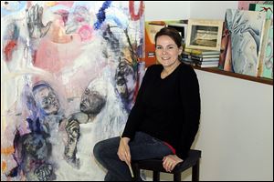 Hillview Elementary art teacher Sarah Vanni, in her studio at her Waterville home, says she disciovered her abstract style while she was a student at Bowling Green State University. Her work on exhibit in Italy is part of a show by Studio Arts Center International of Florence alumni.