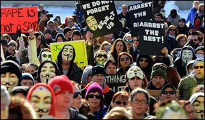 A crowd of 800 to 1,000 people chants and waves signs in eastern Ohio's Steubenville. Saturday's rally lasted more than three hours.