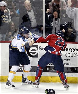 Toledo’s Travis Novak, left, fights with Kalamazoo's Dustin Cloutier during Sunday's game with the Wings. 