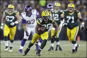 Green Bay Packers running back DuJuan Harris runs through the  the Minnesota Vikings' defense Saturday in Green Bay, Wis. The Packers won 24-10.