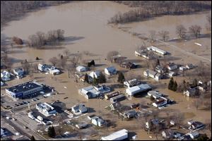 Heavy rains that mixed with melting snow pushed the Blanchard River over its banks, flooding Ottawa, Ohio, in March, 2011. The scene is familiar to area residents; devastating floods have hit the watershed area repeatedly, causing millions of dollars’ worth of property losses.