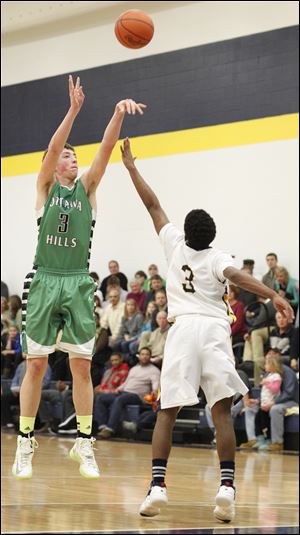 Geoff Beans of Ottawa Hills shoots a 3-pointer against Toledo Christian's Dominique Pittman. Beans finished with 14 points.