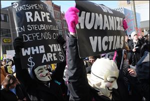 Masked participants rally at Steubenville City Hall to demand justice for a 16-year-old West Virginia girl who allegedly was raped by Steubenville High School football players in eastern Ohio in August. A February trial is set for two teens.