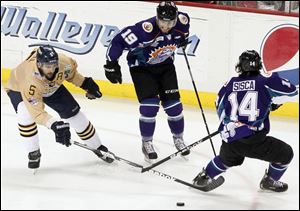 The Walleye's Wes O'Neill tries to get the puck against Orlando's Dan Gendur left, and Mathew Sisca.
