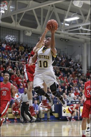 Whitmer's Ricardo Smith, who finished with 30 points, drives against Jackson Lamb.