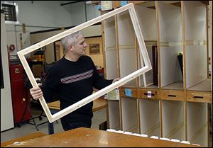From left: Dana Dunbar, Ron Mickel and Laura Jajko poses inside the showroom at American Frame in Maumee, Ohio. Mickel is the father of the two sisters, two-line cutline in three columns.