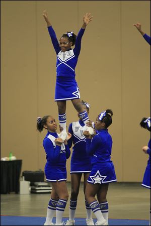 De’Janay Gary, 10, is held aloft by Winterfield Venture Academy teammates from left, Whitney Bankston, 13, Miyon Mickles, 10, and Jaiden Taylor, 14. 