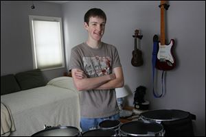 Whitmer High junior Morgan Cox, 16, stands by his quad drum, the  instrument he will play tonight as a member of the All-Star Invitational Marching Band for the BCS Championship Game. 