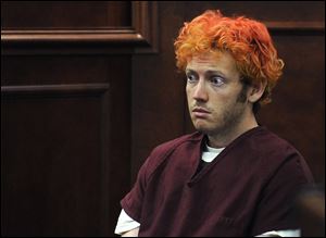 Police said today that James E. Holmes (shown here in an earlier court appearance) appeared relaxed after the shooting in the Colorado theater for which he is accused of killing 12 people. 