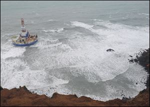 The Royal Dutch Shell drilling rig Kulluk is seen aground off a small island near Kodiak Island on New Year's Day.