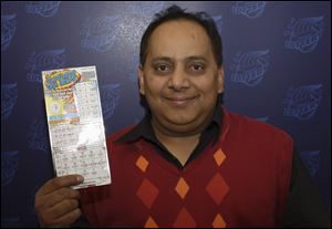 Urooj Khan, 46, of Chicago's West Rogers Park neighborhood, poses with a winning lottery ticket.