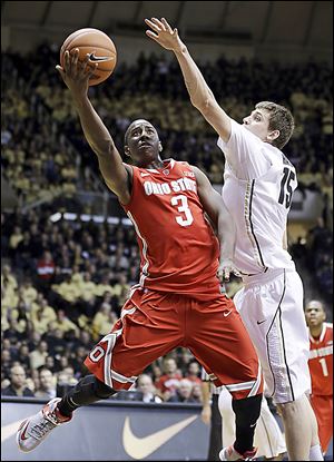 Ohio State guard Shannon Scott shoots under Purdue forward Donnie Hale in the first half Tuesday in West Lafayette, Ind.