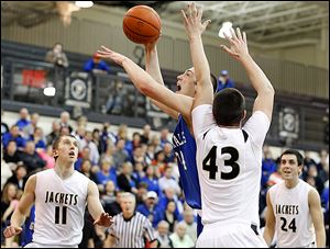 Anthony Wayne's Mark Donnal goes to the net against  Perrysburg's Nate Patterson.