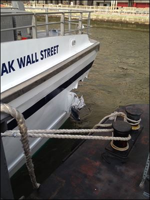 A hole is torn near the bow of the Seastreak Wall Street ferry after it banged into the mooring as it arrived at a pier in New York's financial district today.