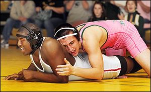 Clay's Eddie Silva, right, controls Central Catholic’s Chris Norwood. Silva won.