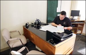 Toledo City Councilman Shaun Enright  fills out paperwork at One Government Center. Wednesday was his first day on the job and critics are riled about his appointment on Tuesday. 