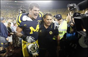 University of Michigan head coach Brady Hoke and player Taylor Lewan (77) head up the tunnel and off the field after defeating Notre Dame in September, 2011.