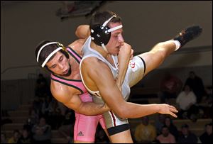Clay's Damon Dominique, left, controls Central Catholic's Colin Kaucher at 152 pounds. Dominique won 5-2 for the Eagles.